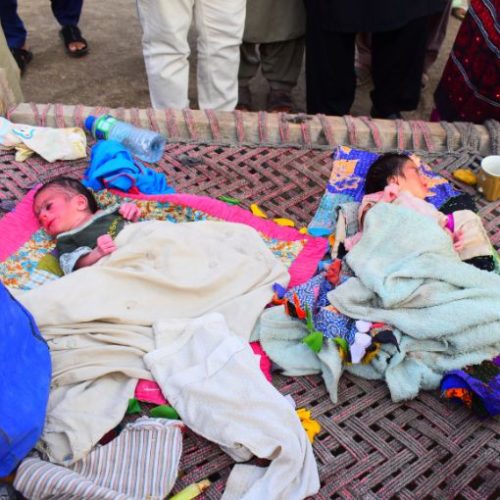 Infants resting during a KnK Japan nutrition distribution