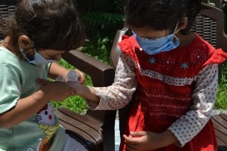 Children washing their hands during a hygiene session
