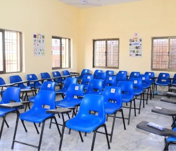 Classroom furnished with student chairs and writing desks