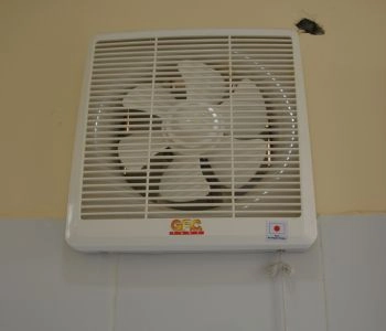 Wall-mounted exhaust fan installed in a facility
