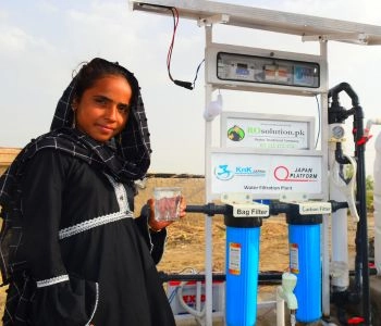 Community member at a solar-powered water filtration plant