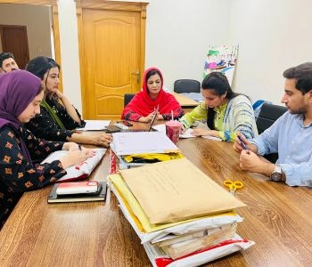 Procurement committee reviewing vendor bids around a table