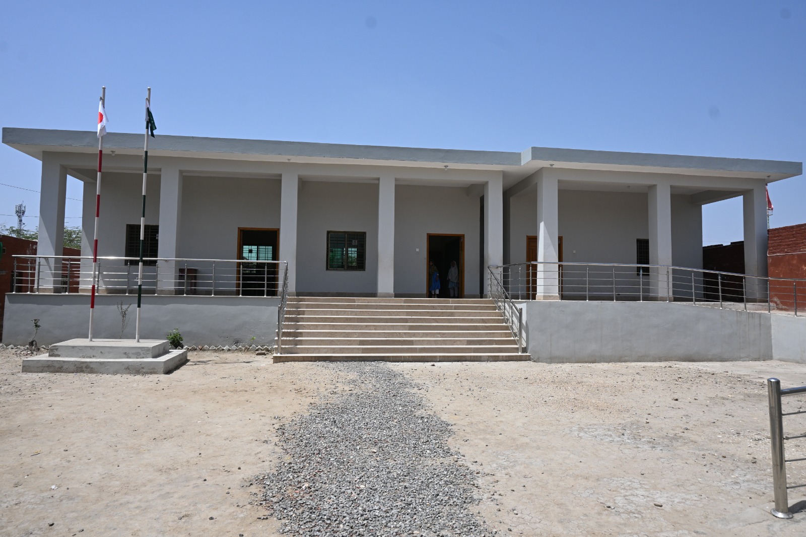 Front of a newly built KnK Japan school with covered porch and ramp