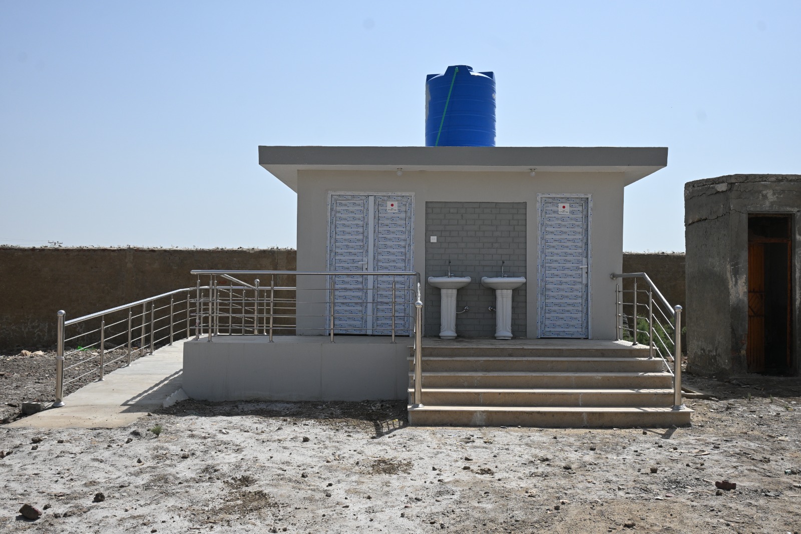Inclusive WASH block with ramp, separate cubicles and water tank